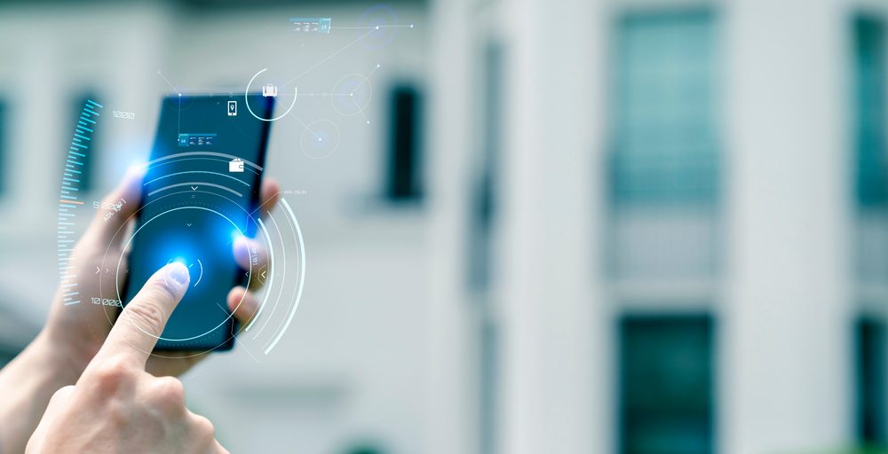 Man with hi-tech smart gadget IoT smart home technology, smart digital lifestyle home automation control online by mobile app.