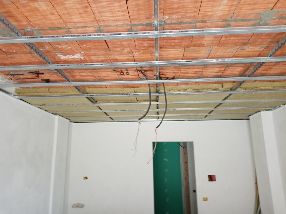 rock wool insulation being installed on a garage ceiling for improved energy efficiency and year‑round comfort